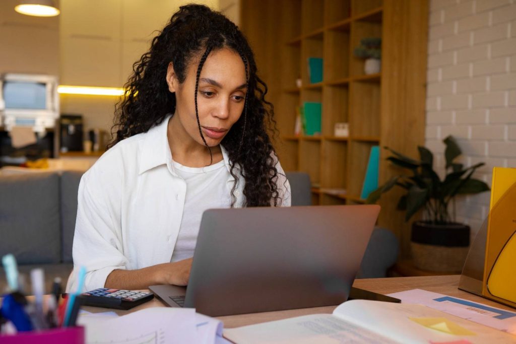 women working on course on laptop